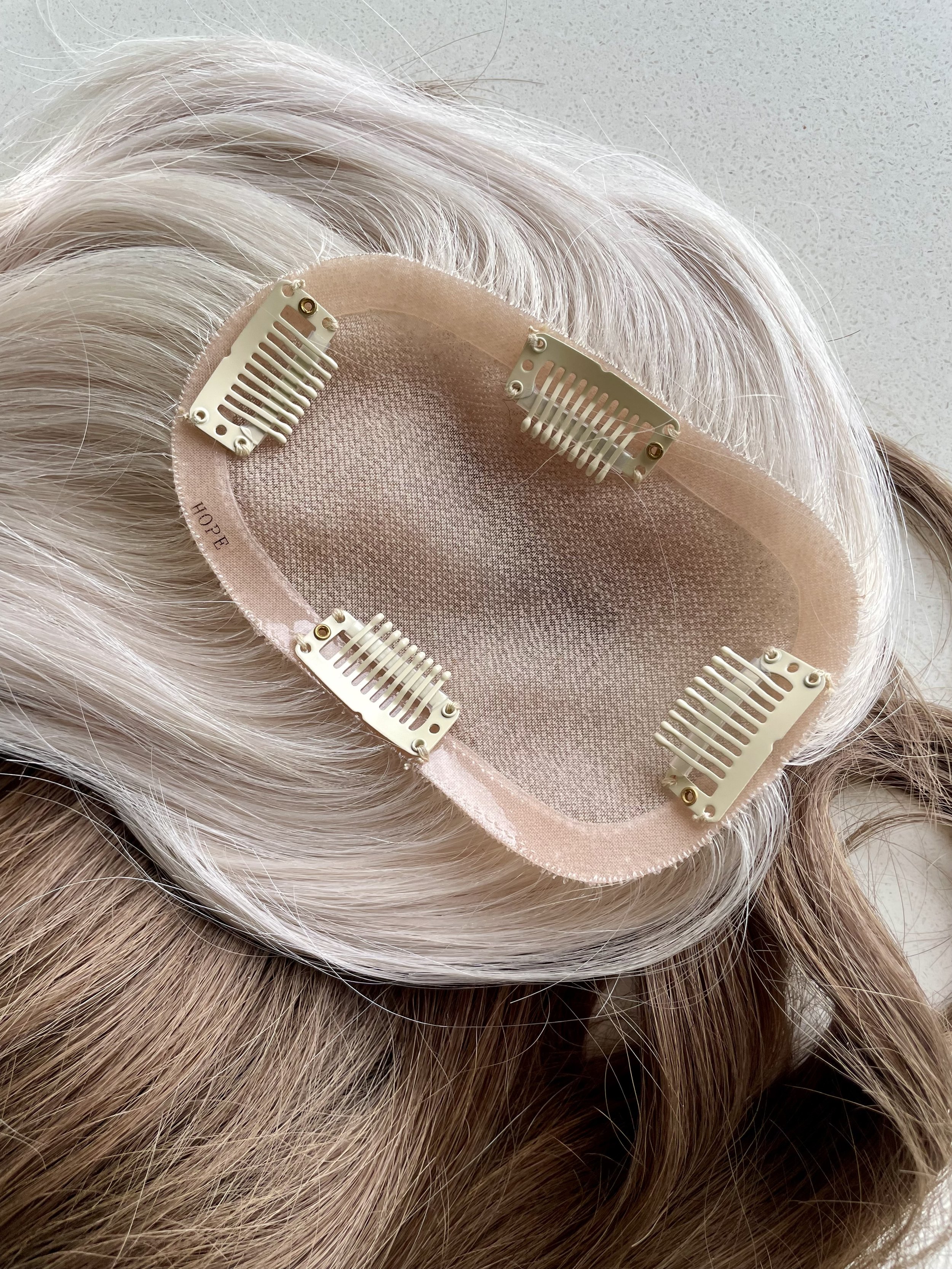 Hair topper showing clip attachment system